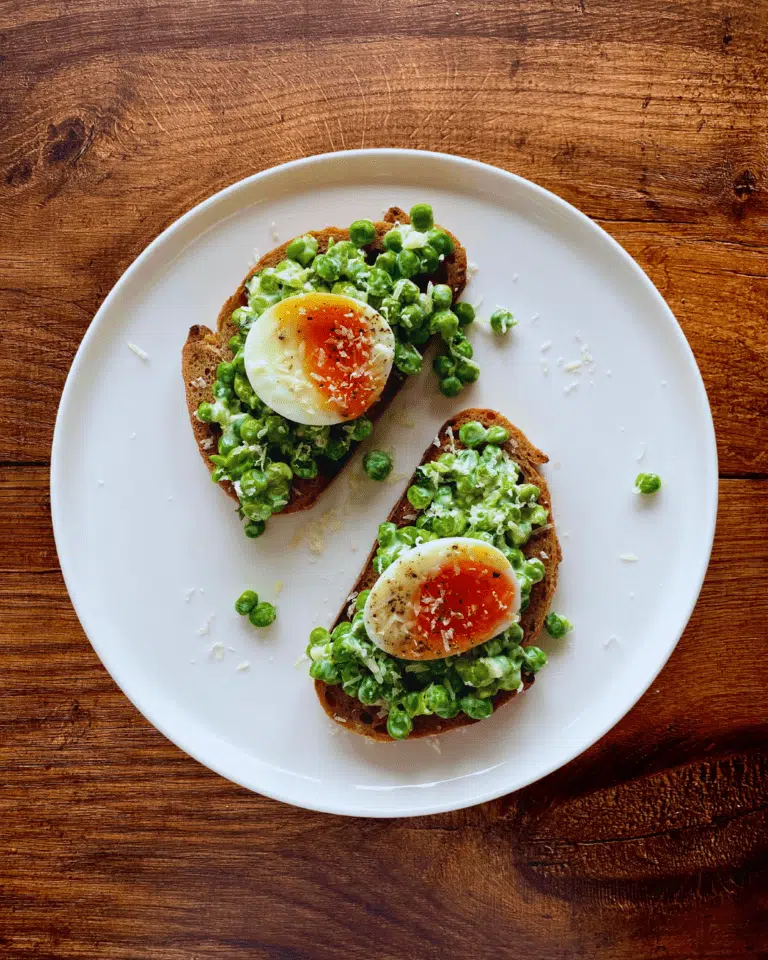 crushed creamy garlic peas on toast with a boiled egg