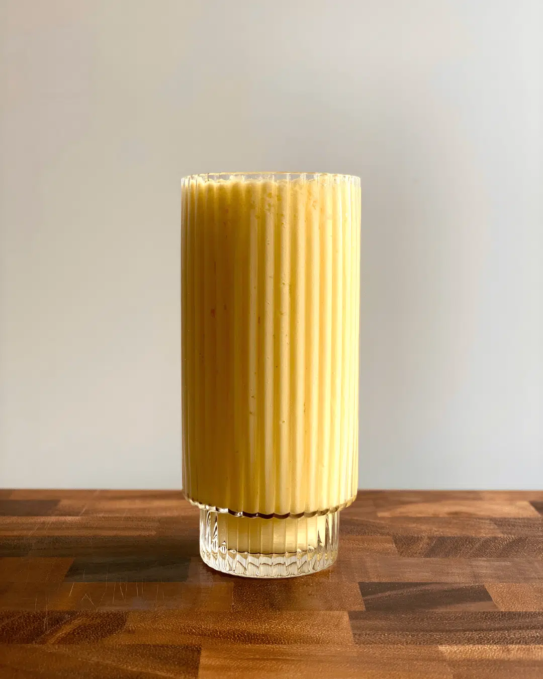 mango smoothie in a tall glass